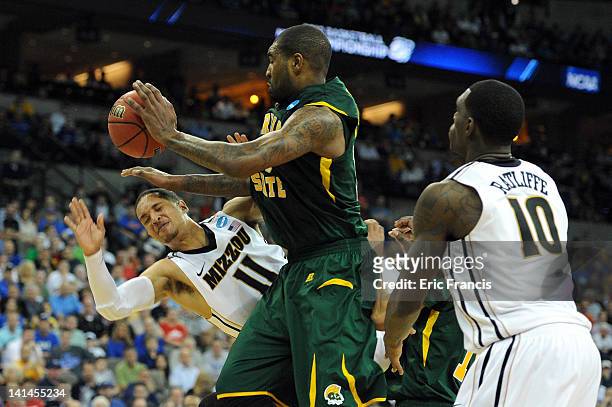 Michael Dixon of the Missouri Tigers loses the ball as he drives against Kyle O'Quinn of the Norfolk State Spartans during the second round of the...