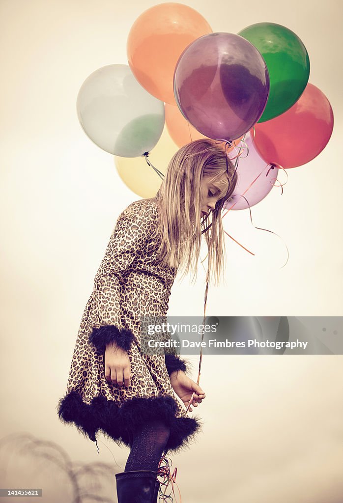 Girl holding colorful balloons