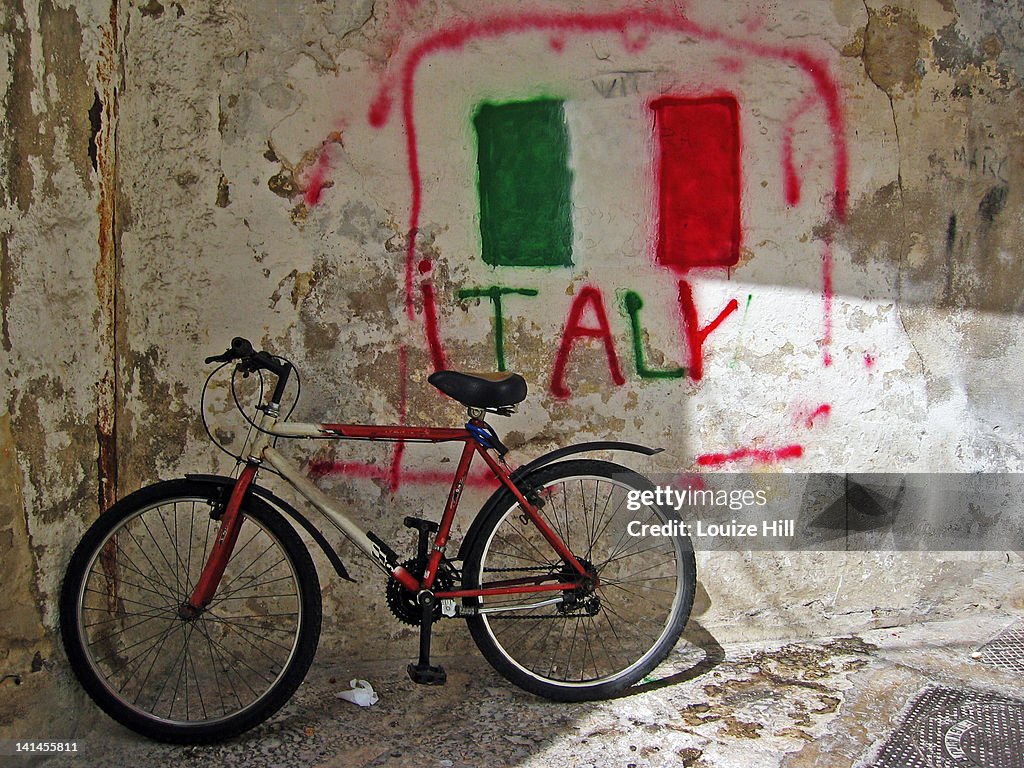 Bicycle leaning on wall