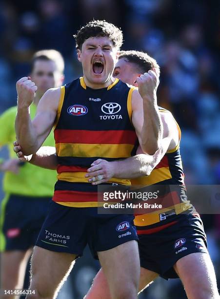 Harry Schoenberg of the Crows celebrates a goal with Rory Laird of the Crows during the round 22 AFL match between the Adelaide Crows and the North...