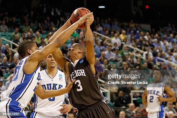 McCollum of the Lehigh Mountain Hawks goes up for a shot over Andre Dawkins and Austin Rivers of the Duke Blue Devils in the first half during the...