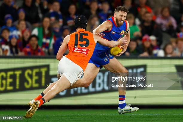 Marcus Bontempelli of the Bulldogs breaks a tackle attempt from Sam Taylor of the Giants during the round 22 AFL match between the Western Bulldogs...