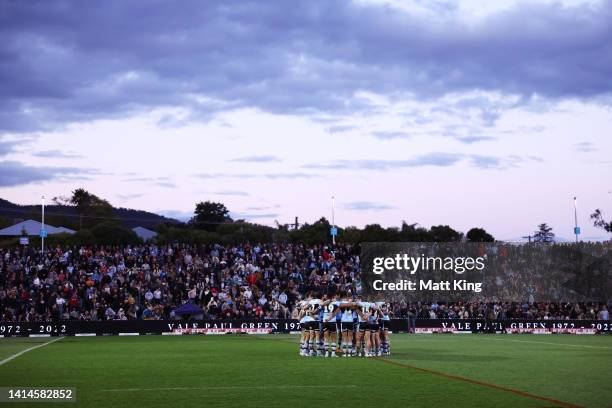 The Sharks observe a moments silence in remembrance of the late Paul Green during the round 22 NRL match between the Wests Tigers and the Cronulla...