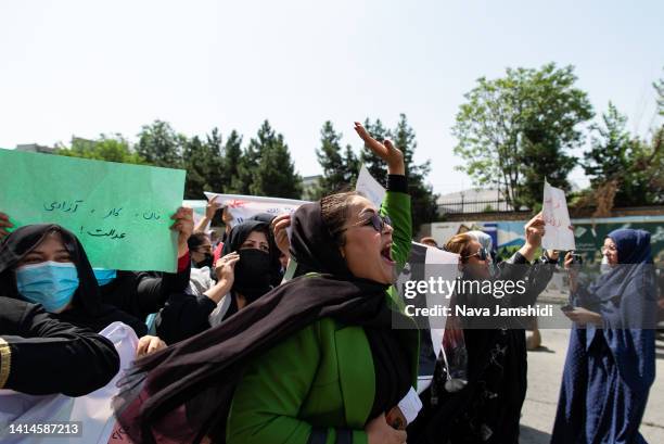 Taliban fighters fired into the air as they dispersed a rare rally by women as they chanted "Bread, work and freedom" and marched in front of the...