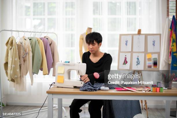 this asian man is sewing with his sewing machine. - atelier ストックフォトと画像