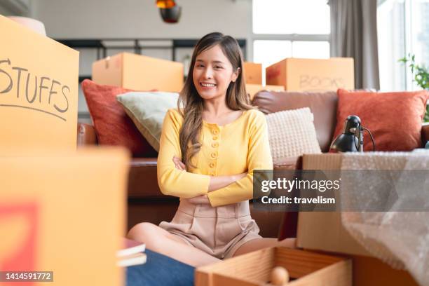 say goodbye to old house,asian female young adult look at camera hand chest ready to say goodbye ready to move everything after finish packing relocation moving to the new house,home moving ideas concept - declutter stockfoto's en -beelden