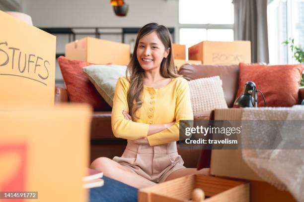 say goodbye to old house,asian female young adult look at camera hand chest ready to say goodbye ready to move everything after finish packing relocation moving to the new house,home moving ideas concept - woman flat chest 個照片及圖片檔