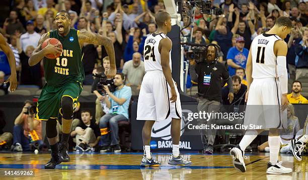 Norfolk State Spartans center Kyle O'Quinn , left, runs off the court in celebration, while Missouri Tigers guards Kim English and Michael Dixon...