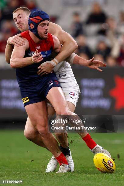 Harry McKay of the Blues tackles Angus Brayshaw of the Demons during the round 22 AFL match between the Melbourne Demons and the Carlton Blues at...