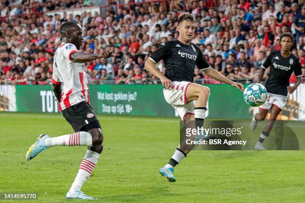 Jordan Teze of PSV Eindhoven fights for the ball with Aleksandr Golovin of AS Monaco during the UEFA Champions League Qualification match between PSV...