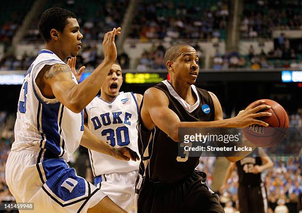McCollum of the Lehigh Mountain Hawks moves the ball against Tyler Thornton and Seth Curry of the Duke Blue Devils in the second half during the...