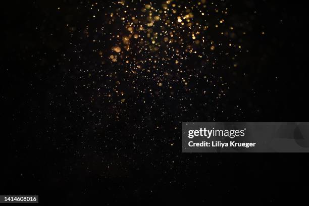 abstract gold glitter/dusk background. - gold glitter stockfoto's en -beelden