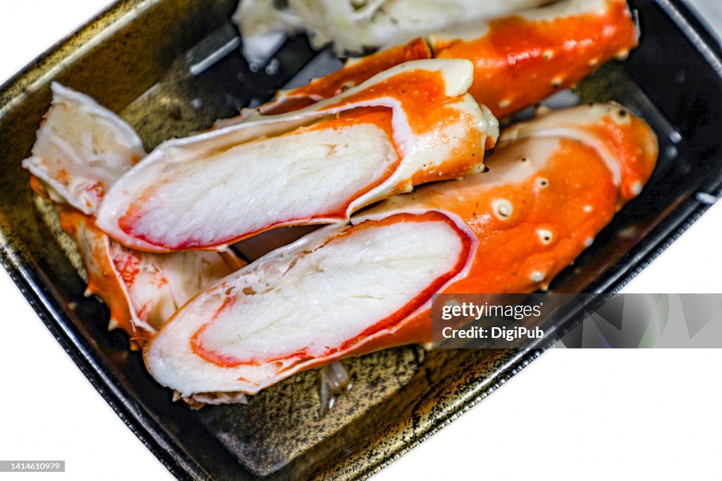 Boiled king crab legs in disposable plastic tray