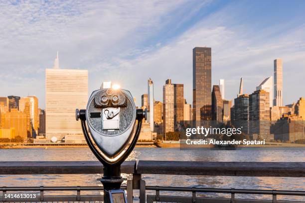 touristic binoculars overlooking new york city skyline at sunrise, usa - east river staden new york bildbanksfoton och bilder