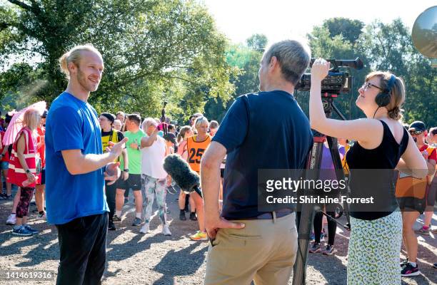 Jonnie Peacock is interviewed during The National Lottery Park Run at Heaton Park on August 13, 2022 in Manchester, England.