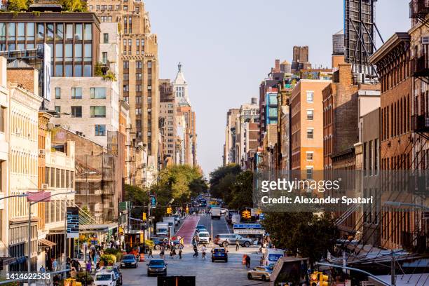 street in meatpacking district on a sunny day, new york city, usa - soho new york stockfoto's en -beelden