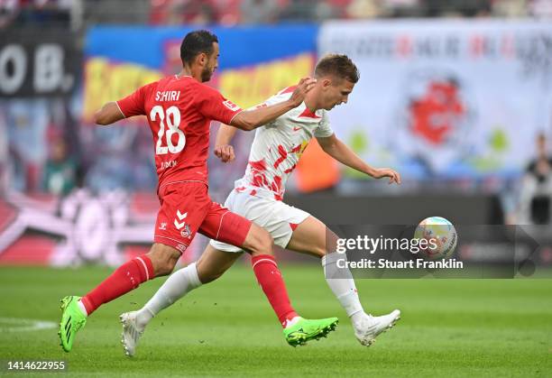 Ellyes Skhiri of 1. FC Köln and Dani Olmo of RB Leipzig compete for the ball during the Bundesliga match between RB Leipzig and 1. FC Köln at Red...