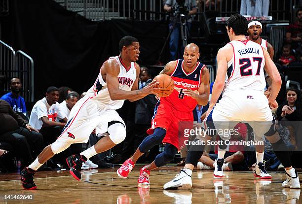 Joe Johnson of the Atlanta Hawks moves the ball against Maurice Evans of the Washington Wizards on March 16, 2012 at Philips Arena in Atlanta,...