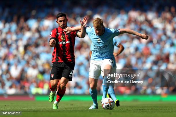 Lewis Cook of AFC Bournemouth battles for possession with Kevin De Bruyne of Manchester City during the Premier League match between Manchester City...
