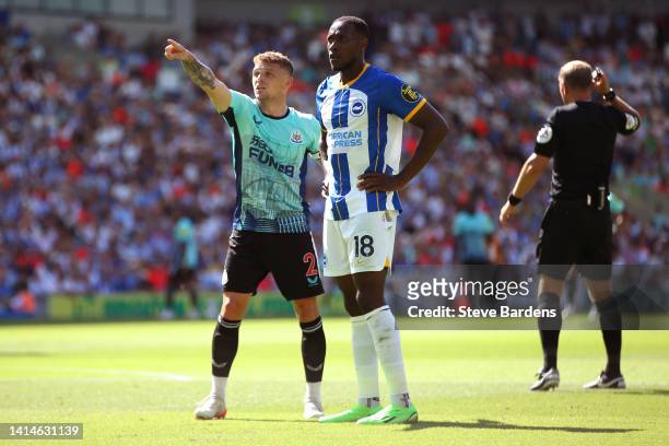 Kieran Trippier of Newcastle United points to the stand as Danny Welbeck of Brighton & Hove Albion looks on during the Premier League match between...