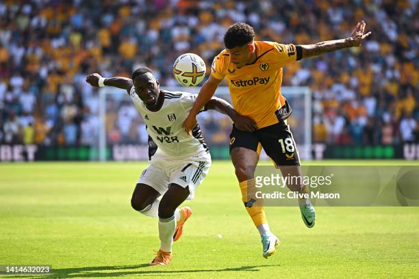 Morgan Gibbs-White of Wolverhampton Wanderers is challenged by Neeskens Kebano of Fulham during the Premier League match between Wolverhampton...