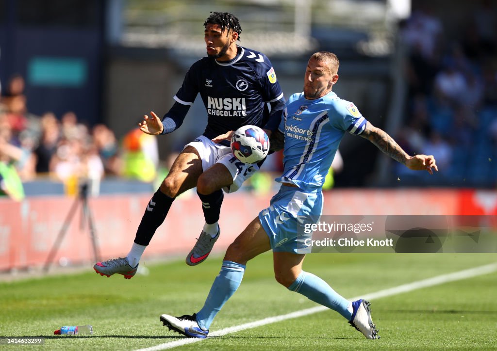 Tyler Burey of Millwall and Martyn Waghorn of Coventry City battle