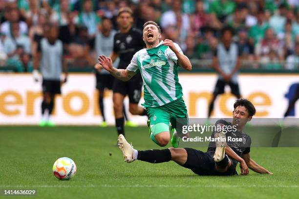Mitchell Weiser of Werder Bremen is fouled by Hiroki Ito of VfB Stuttgart during the Bundesliga match between SV Werder Bremen and VfB Stuttgart at...
