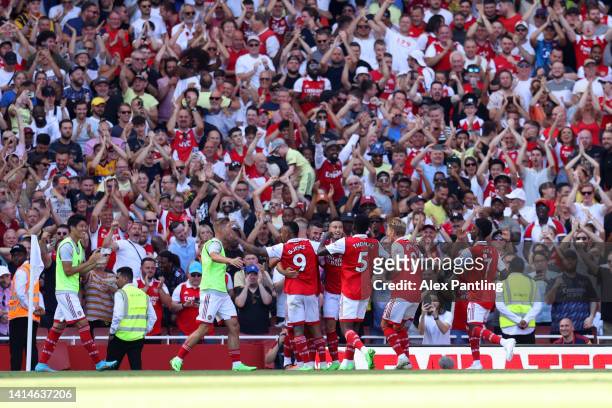 Granit Xhaka of Arsenal celebrates with teammates after scoring their side's third goal during the Premier League match between Arsenal FC and...