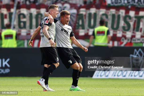 Andre Hahn of FC Augsburg celebrates with team mate Florian Niederlechner after scoring their sides second goal during the Bundesliga match between...