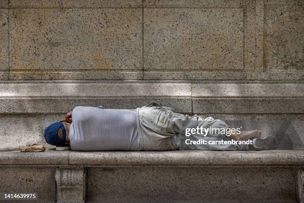 man sleeping on a stone bench - homeless person summer stock pictures, royalty-free photos & images