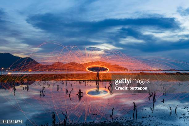 creative light painting by burning steelwool - burning steel wool firework stock-fotos und bilder