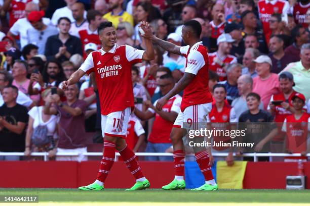 Gabriel Martinelli of Arsenal celebrates with team mate Gabriel Jesus after scoring their sides fourth goal during the Premier League match between...