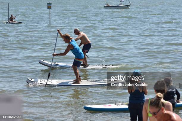 Two men race on paddleboards on Chalkwell beach during the extreme hot weather on August 13, 2022 in Chalkwell, Southend, England. The Met Office,...