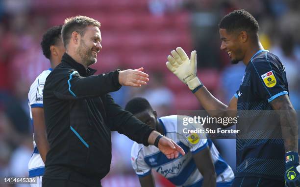 Goalkeeper Seny Dieng celebrates with manager Michael Beale after scoring the second QPR goal during the Sky Bet Championship between Sunderland and...