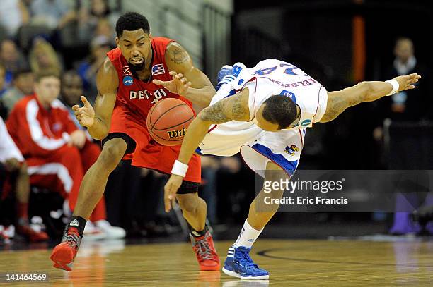Chase Simon of the Detroit Titans chases down a loose ball against Travis Releford of the Kansas Jayhawks during the second round of the 2012 NCAA...