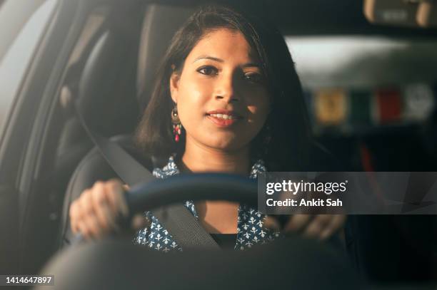 young success happy  woman driving a car at sunset - indian ethnicity car stock pictures, royalty-free photos & images