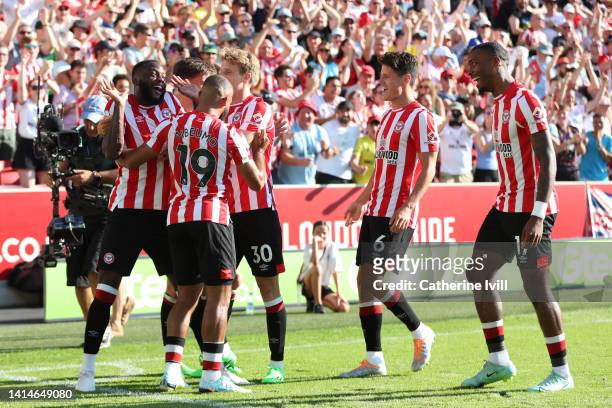 Josh Dasilva of Brentford celebrates with team mates after scoring their sides first goal during the Premier League match between Brentford FC and...