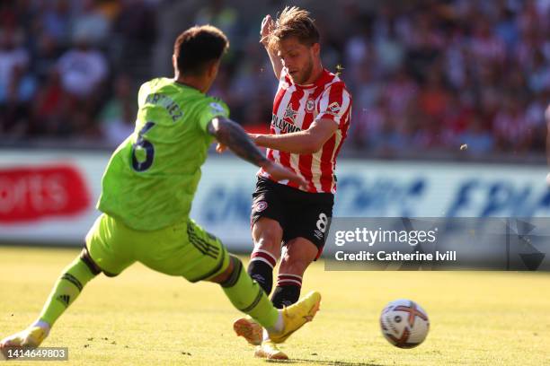 Mathias Jensen of Brentford scores their sides second goal during the Premier League match between Brentford FC and Manchester United at Brentford...