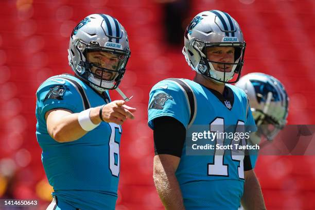 Baker Mayfield and Sam Darnold of the Carolina Panthers warmup before the preseason game against the Washington Commanders at FedExField on August...