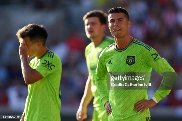 Cristiano Ronaldo and Lisandro Martinez of Manchester United look dejected during the Premier League match between Brentford FC and Manchester United...