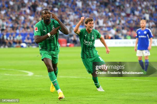 Marcus Thuram of Borussia Monchengladbach celebrates after scoring their sides second goal during the Bundesliga match between FC Schalke 04 and...