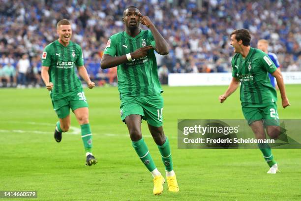 Marcus Thuram of Borussia Monchengladbach celebrates after scoring their sides second goal during the Bundesliga match between FC Schalke 04 and...