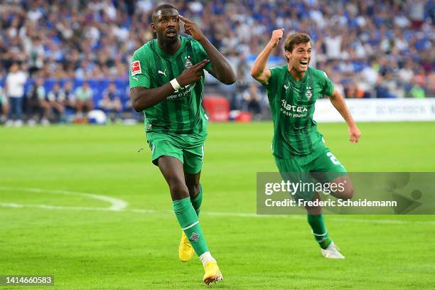 Marcus Thuram of Borussia Monchengladbach celebrates after scoring their sides second goal during the Bundesliga match between FC Schalke 04 and...