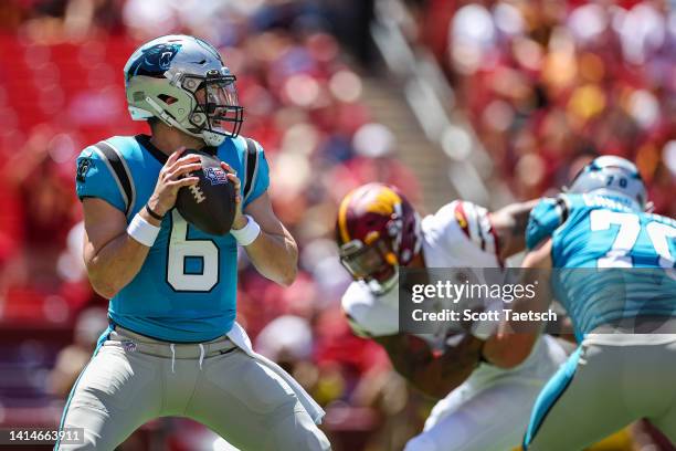 Baker Mayfield of the Carolina Panthers looks to pass against the Washington Commanders during the first half of the preseason game at FedExField on...