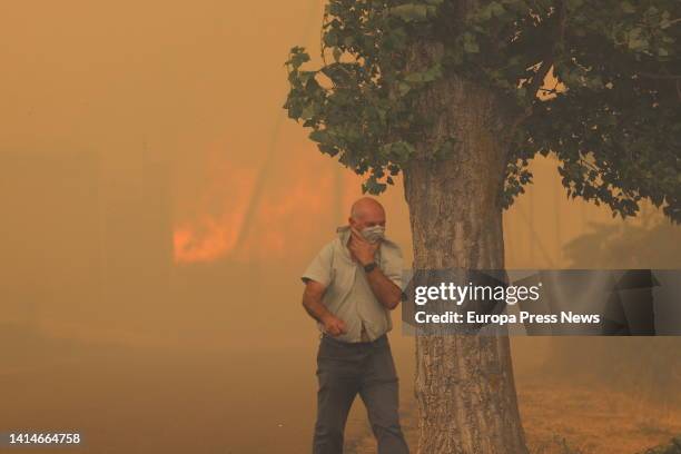 Resident flees from the flames on August 13 in Añon de Moncayo, Zaragoza, Aragon, Spain. A fire declared this Saturday in the municipality of Añon de...