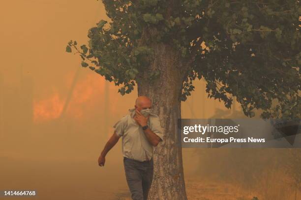 Resident flees from the flames on August 13 in Añon de Moncayo, Zaragoza, Aragon, Spain. A fire declared this Saturday in the municipality of Añon de...