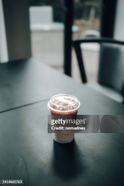 ice latte coffee in plastic cup on wood table. - morning wood 個照片及圖片檔