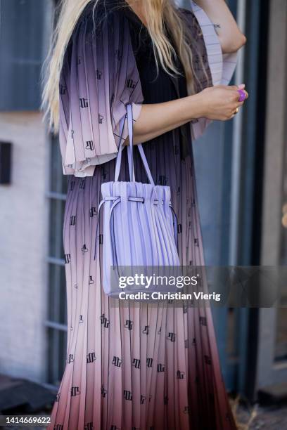 Guest is seen wearing shaded multi colored dress, purple bucket bag, sneaker outside Munthe during Copenhagen Fashion Week Spring/Summer 2023 on...