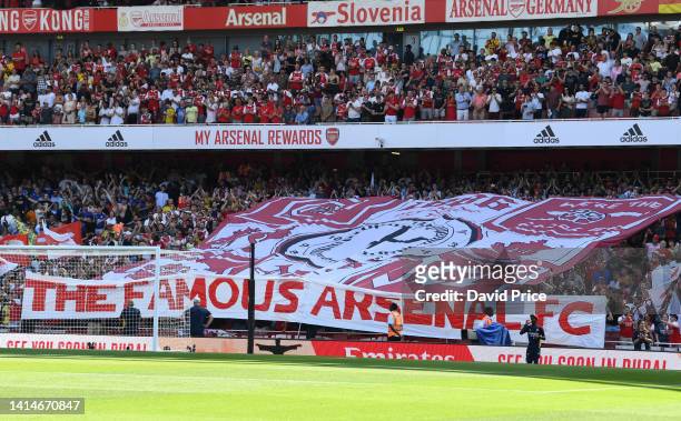 Arsenal fans hold up a banner before the Premier League match between Arsenal FC and Leicester City at Emirates Stadium on August 13, 2022 in London,...