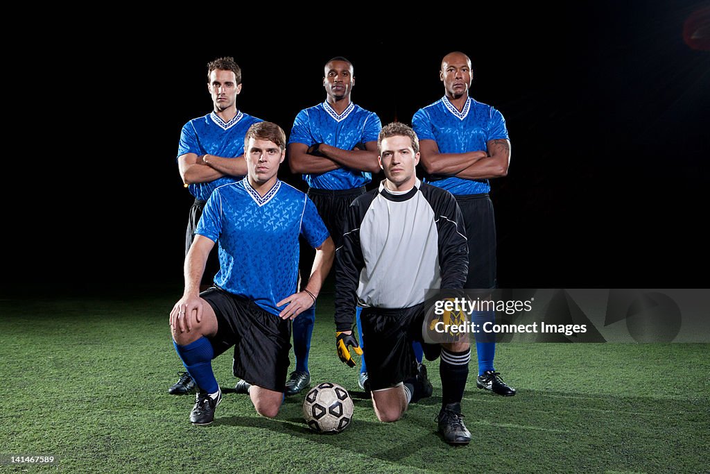 Soccer team on pitch at night